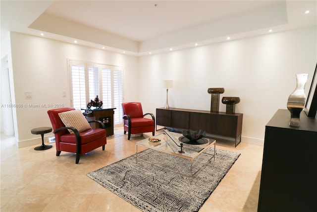 sitting room featuring a raised ceiling