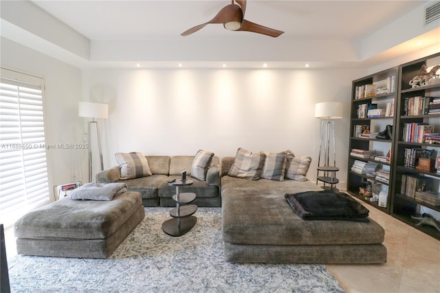 living room with tile patterned floors and ceiling fan