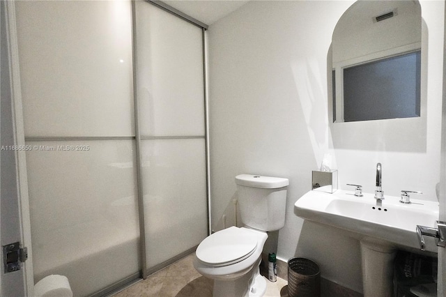 bathroom featuring toilet, tile patterned flooring, and sink