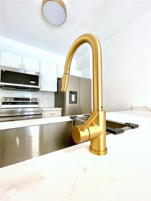 kitchen featuring appliances with stainless steel finishes and white cabinetry