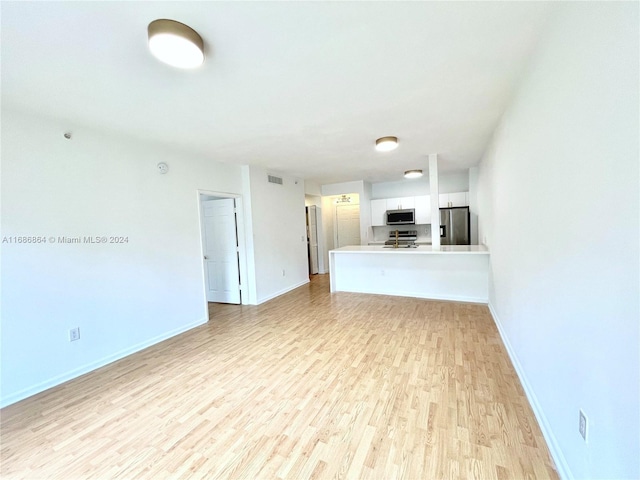 unfurnished living room featuring light hardwood / wood-style flooring