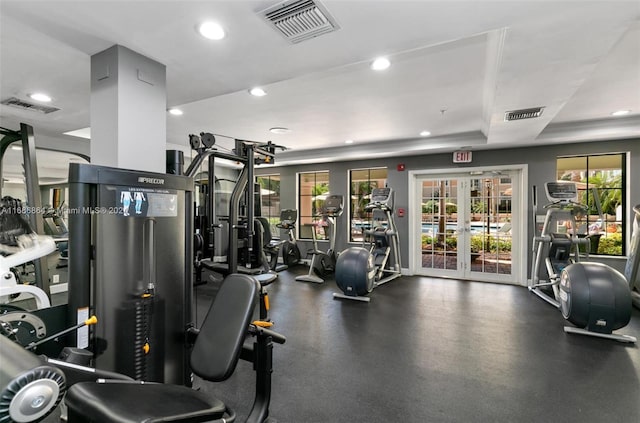 exercise room with french doors and a tray ceiling