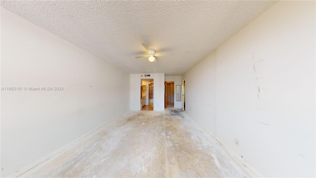 spare room featuring ceiling fan and a textured ceiling