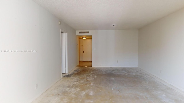 empty room featuring a textured ceiling