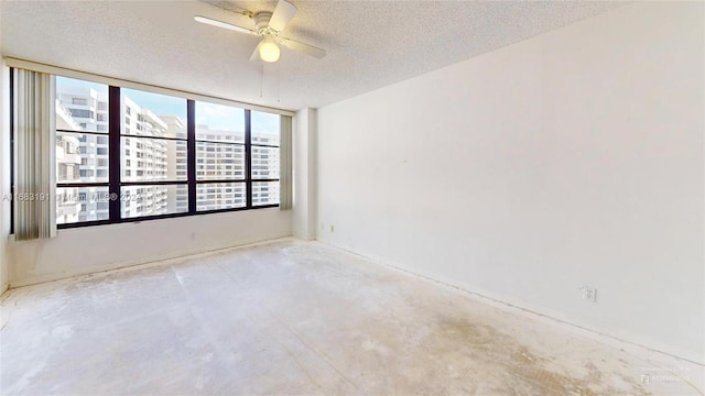 unfurnished room with a wealth of natural light, a textured ceiling, and ceiling fan