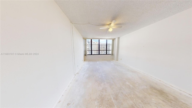 unfurnished room with a textured ceiling, hardwood / wood-style floors, and ceiling fan