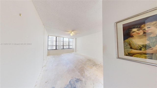 spare room featuring a textured ceiling and ceiling fan