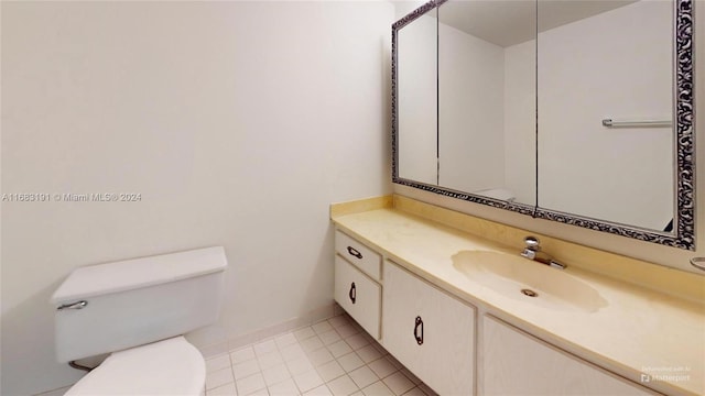 bathroom featuring vanity, toilet, and tile patterned flooring