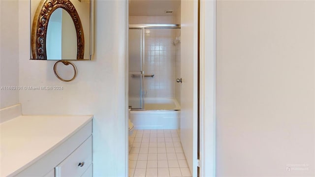 full bathroom with vanity, toilet, tile patterned floors, and combined bath / shower with glass door