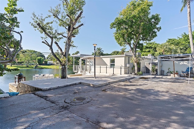 6616 E Miami Lakes Dr E, Miami Lakes, FL 33014 - dock area featuring a water view and a patio