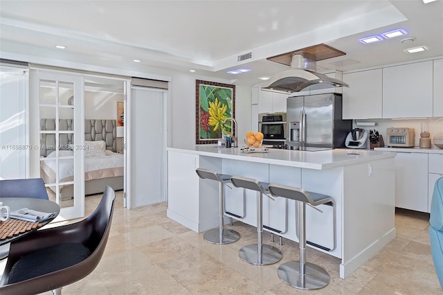 6616 E Miami Lakes Dr E, Miami Lakes, FL 33014 - kitchen featuring appliances with stainless steel finishes, modern cabinets, white cabinets, light countertops, and a breakfast bar