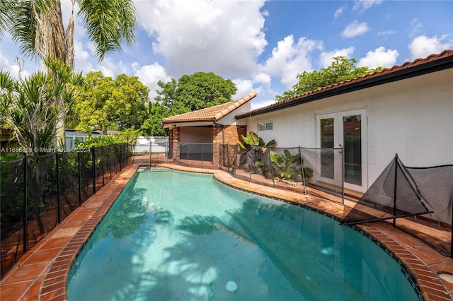 view of pool with french doors