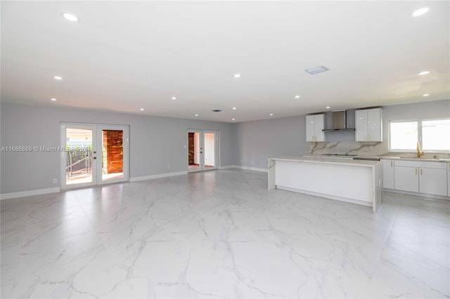 kitchen with white cabinets, sink, a wealth of natural light, and french doors