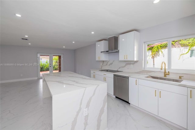 kitchen with white cabinetry, a center island, sink, wall chimney range hood, and stainless steel dishwasher