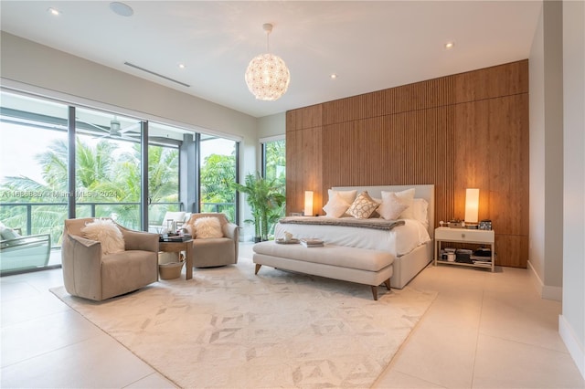 bedroom featuring access to outside, wooden walls, and a notable chandelier