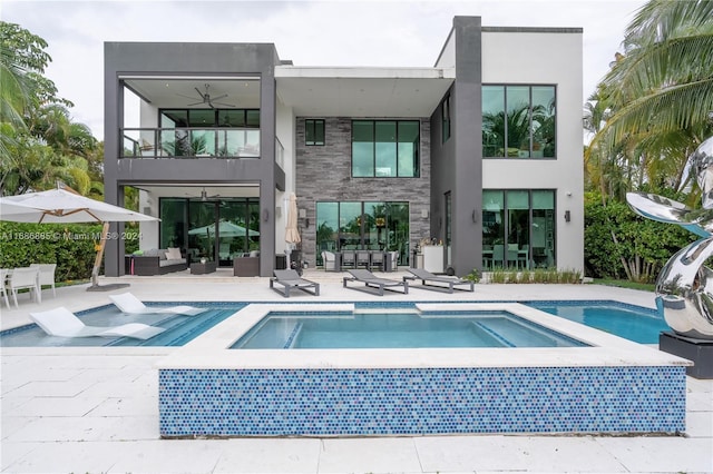 back of house featuring outdoor lounge area, ceiling fan, a balcony, and a patio