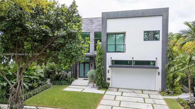 modern home featuring a front lawn and a garage