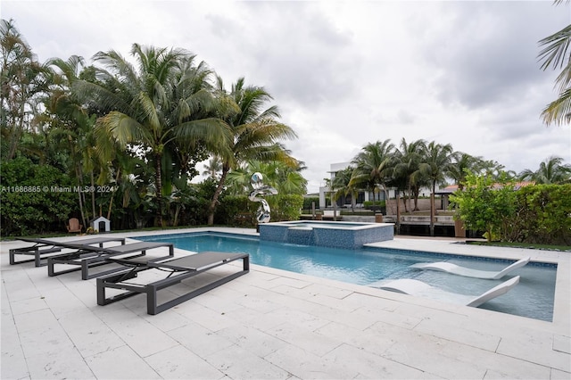 view of pool featuring an in ground hot tub and a patio