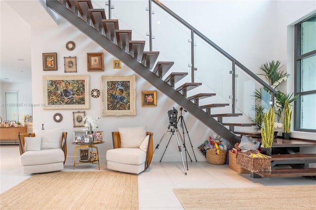 stairway featuring a high ceiling