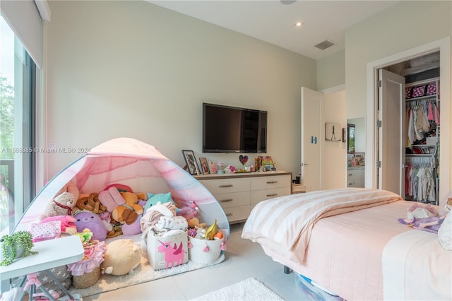 bedroom featuring multiple windows and a closet