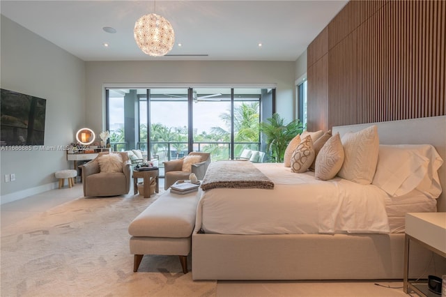 carpeted bedroom featuring access to exterior and a notable chandelier