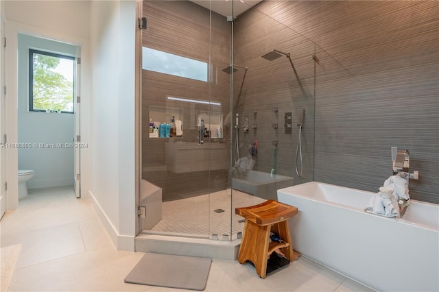 bathroom with toilet, tile patterned floors, and independent shower and bath