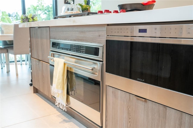 kitchen with light brown cabinets and oven