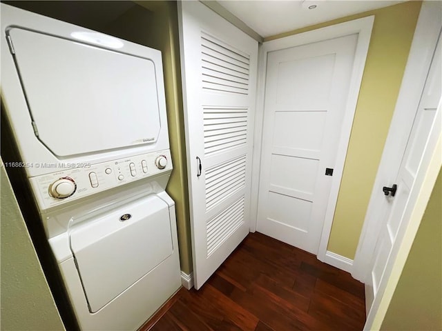 clothes washing area with stacked washer / dryer and dark hardwood / wood-style floors