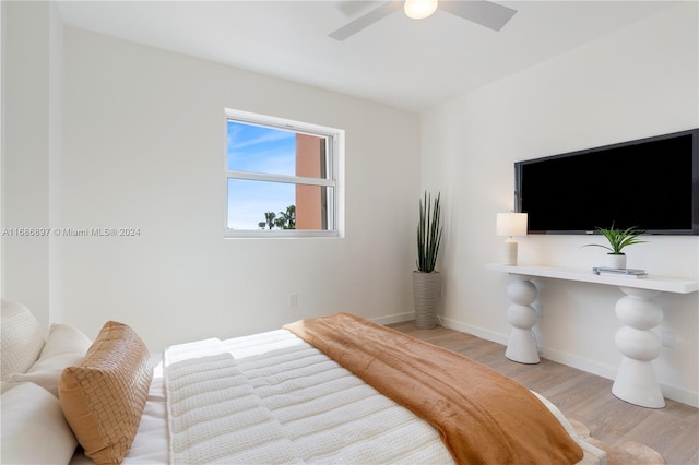 bedroom with ceiling fan and light hardwood / wood-style floors