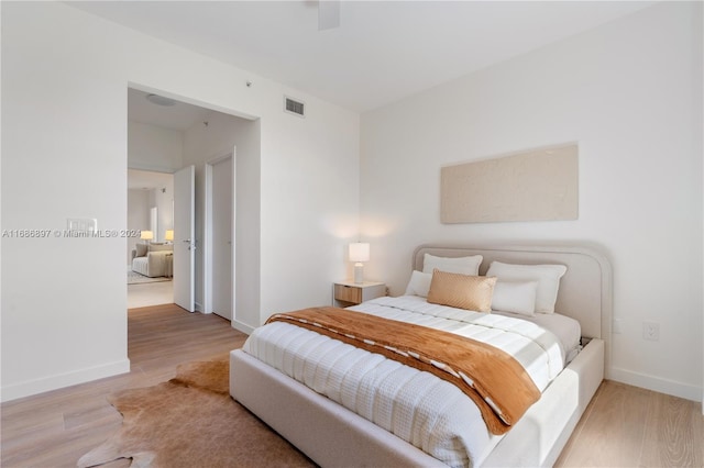 bedroom with ceiling fan and light hardwood / wood-style floors