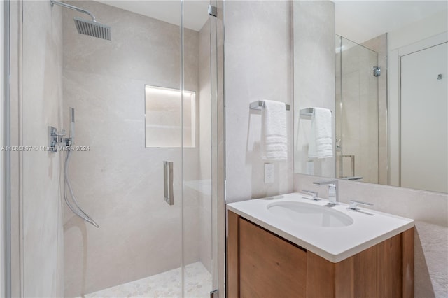 bathroom featuring vanity and an enclosed shower