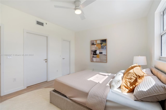 bedroom with light wood-type flooring and ceiling fan