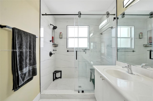 bathroom with vanity and a shower with shower door