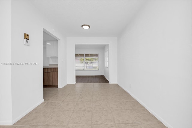 corridor with light tile patterned floors