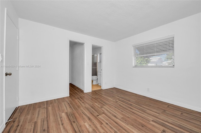 empty room featuring hardwood / wood-style floors and a textured ceiling