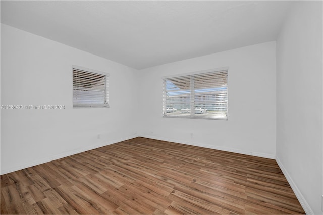 empty room with wood-type flooring