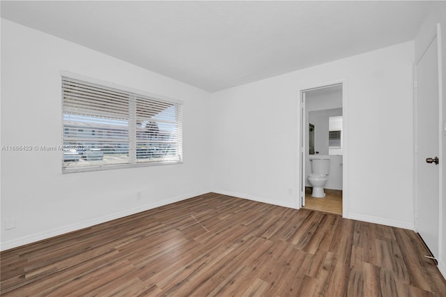 empty room with hardwood / wood-style floors