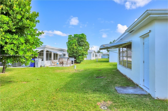 view of yard with a patio area and a sunroom