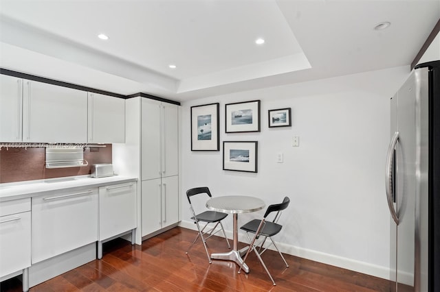 kitchen featuring white cabinetry, dark wood-type flooring, and stainless steel fridge