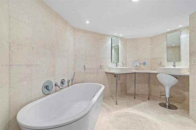 bathroom with a tub to relax in, tile walls, and tile patterned flooring