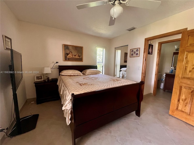 tiled bedroom featuring ceiling fan