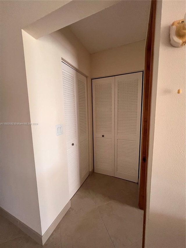 corridor with tile patterned flooring