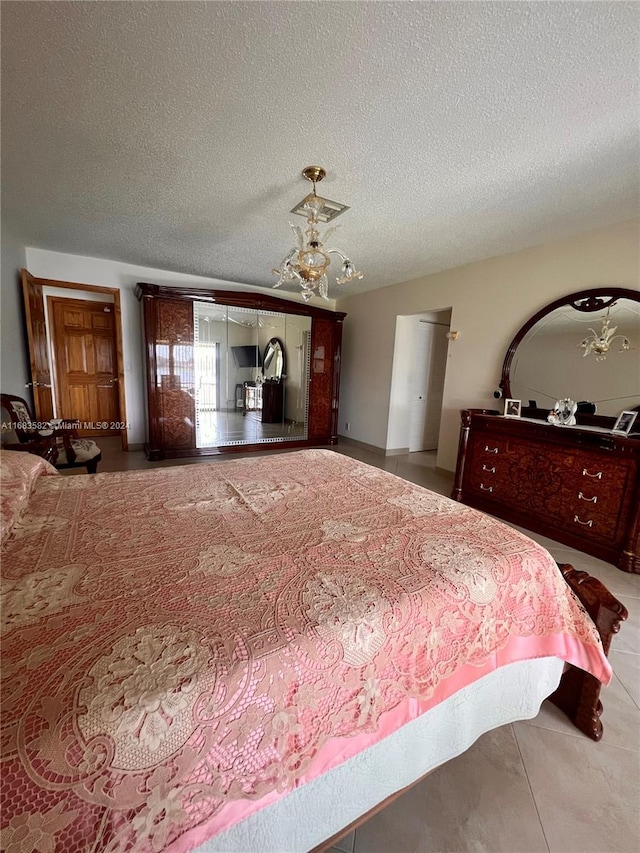 bedroom featuring tile patterned floors and a textured ceiling