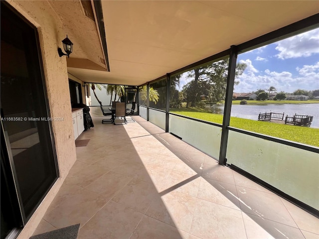 unfurnished sunroom with a water view