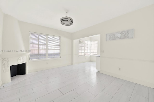 unfurnished living room featuring a large fireplace