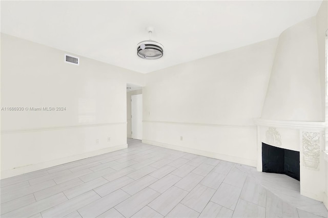 interior space with a tile fireplace