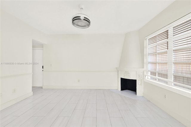 unfurnished living room featuring a large fireplace