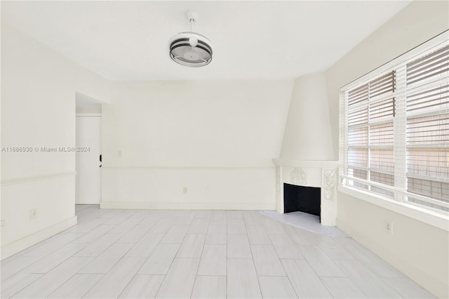 610 8th St Unit 102, Miami Beach, FL 33139 - unfurnished living room with plenty of natural light and a large fireplace