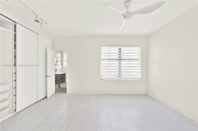 unfurnished bedroom with ceiling fan and a closet