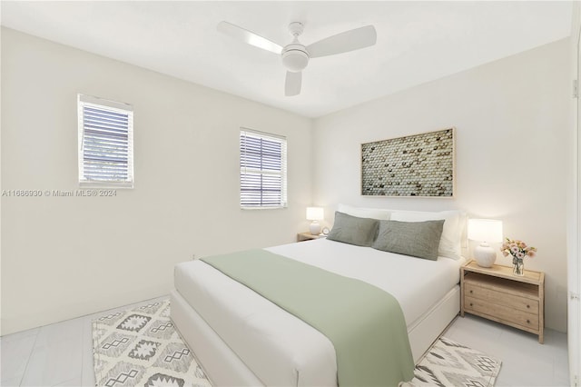 bedroom with ceiling fan and light tile patterned flooring